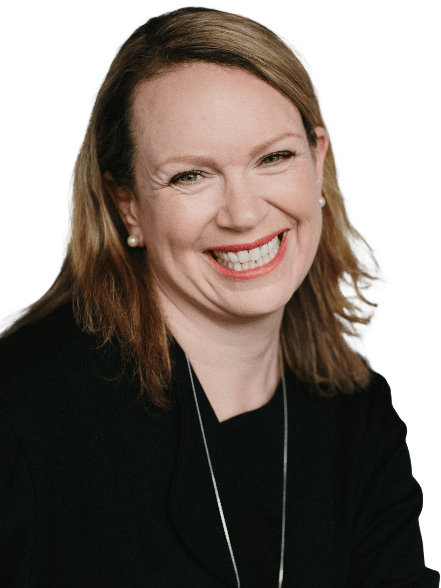 A woman named Ruth is smiling brightly, wearing a black top, pearl earrings, and a necklace. She has light brown hair parted to the side and is looking directly at the camera.